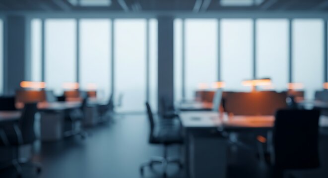 Blurred view of a modern office interior with desks and windows