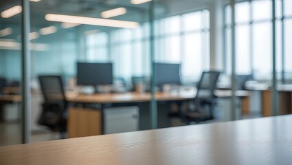 Blurred view of a modern office workspace with desks and computers