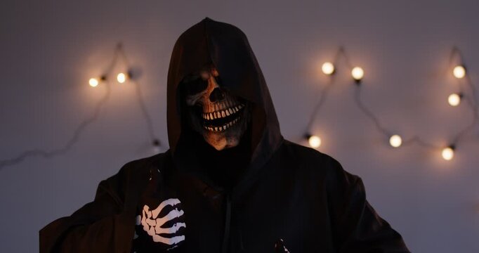 Frightening portrait of the evil grim reaper giving a thumbs up. The terrible and nightmare inducing skeleton figure adds a horror element, making it a striking and monstrous image.