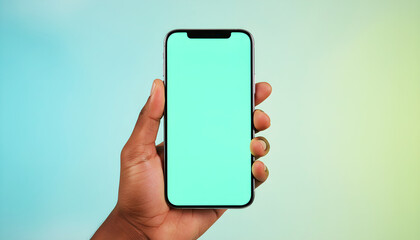 Hand holding smartphone with bright green screen on soft neutral background. High-quality mobile mockup for app design, digital marketing, UI/UX presentation, and chroma key use.