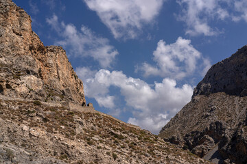 collection of photographs showcasing the dramatic natural beauty of the Kourtaliotiko Gorge in Crete. The images highlight steep rocky cliffs, winding river streams, lush vegetation