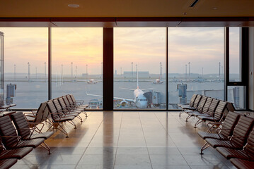 Airport departure lounge at sunset, travel concept.