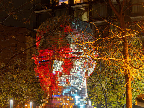 Illuminated, night photo of Kafka's Head - the famous moving sculpture by David Cerny in Prague. Prague, Czech Republic, 11.07.25