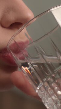 Close up thirsty woman girl drinking clean water in morning healthy habit hydration balance smiling Caucasian female drink glass mineral refresh wellness beauty routine freshness health care start day