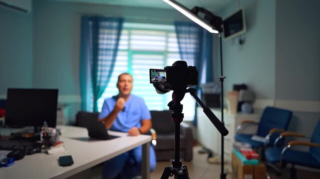 Doctor's office with camera on tripod and light equipment. Medical blog content recording. Selective focus.