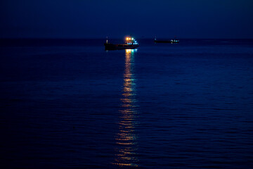 A ship in the harbor at night