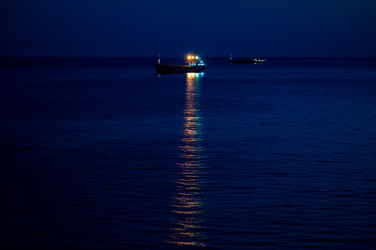 A ship in the harbor at night - Powered by Adobe