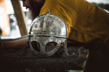 Fototapeta premium A beautiful knight's helmet lies on the table. A metal helmet.