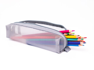 Colored pencils in a gray pencil case on a white background