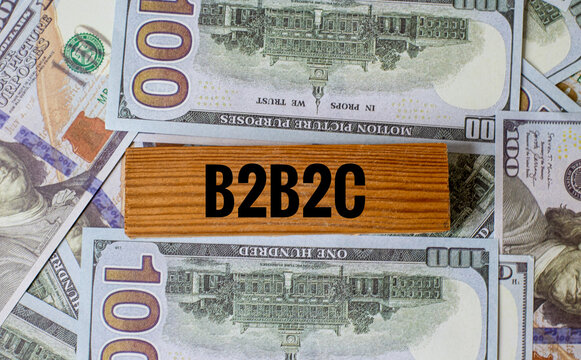 B2B2C Business Model: Wooden Block with Acronym on a Background of US One Hundred Dollar Bills Representing Tripartite Commerce