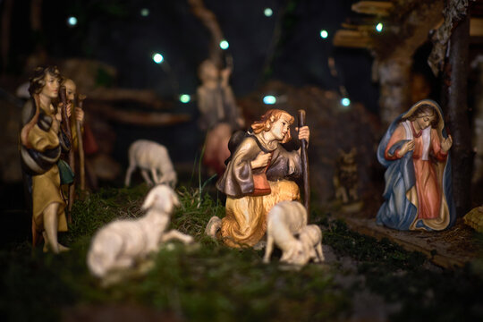 A Christmas manger scene with beautifully carved figures, including Jesus, Mary, Joseph, shepherds and animals. Emotions visible on the characters' faces.