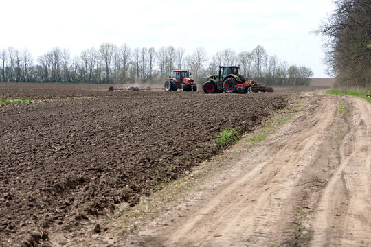 Kyiv, Ukraine. 05.01.2021. two tractors in a field, agricultural field. tractor working in the field, harvesting, business, agriculture. soil preparation, spring season. farming in Ukraine. editorial