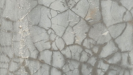 Close-up of polished concrete wall with fine cracks and spider-web pattern. Industrial background