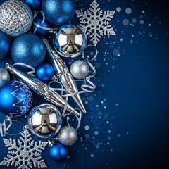 Elegant arrangement of blue and silver christmas ornaments on dark background