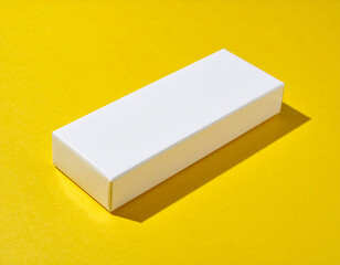Minimalist White Packaging Box Displayed on a Vibrant Yellow Background for Branding and Product Mockup Presentation