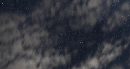 Stars behind fast moving clouds at night