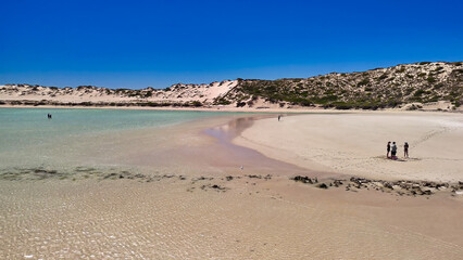 Aerial view of Coral Bay and beach in Western Australia with turquoise ocean and white sand