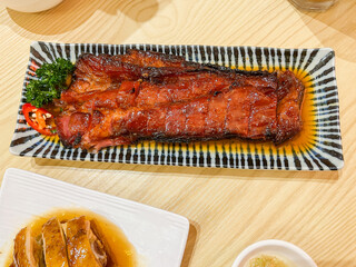 A selection of classic Cantonese dim sum including char siu barbecue pork, shrimp dumplings, rose soy chicken, and molten custard buns. The dishes showcase traditional Hong Kong flavors with vibrant