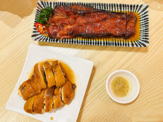 A selection of classic Cantonese dim sum including char siu barbecue pork, shrimp dumplings, rose soy chicken, and molten custard buns. The dishes showcase traditional Hong Kong flavors with vibrant