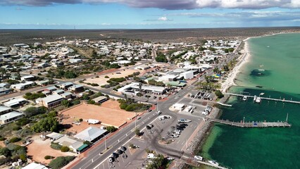 Obraz premium Scenic drone panorama of Denham WA showing harbor, beaches, and clear blue sky