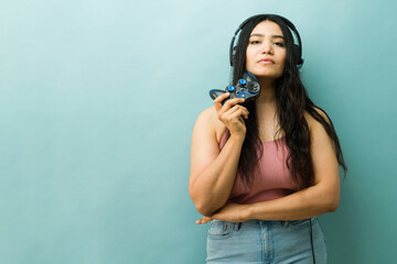 Woman gamer holding controller wearing headphones © AntonioDiaz