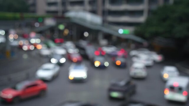blurred out of focus view to street road full with traffic cars and buses transportation in day time in Chengdu city center, blurred traffic jam transportation
