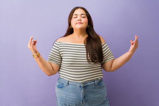 Plus size woman meditating practicing mindfulness and relaxation