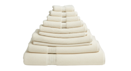 Stacked beige towels pyramid on white background