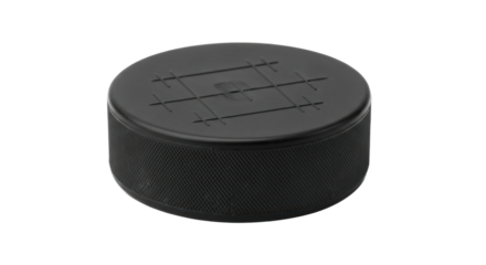 Close-up of black hockey puck on black background with textured surface