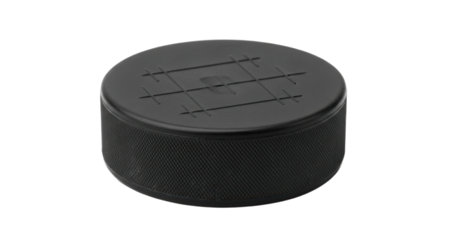 Close-up of black hockey puck on black background with textured surface