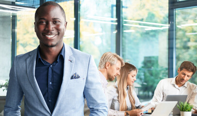 Handsome cheerful african american executive businessman at the workspace office