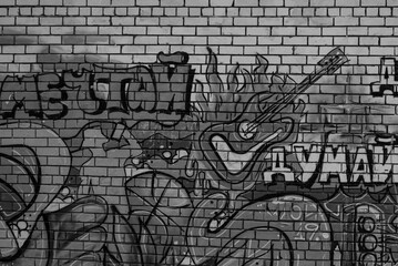Colorful urban graffiti with guitar on brick wall