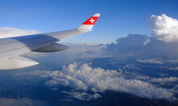 SWISS Airlines Airbus A220 wing and clouds over Lake Geneva, Switzerland