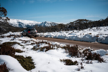 Ice on the road on a mountain in winter in australia mountain in a national park looking over a city below, mt wellington hobart tasmania australia in summer. snow on the roads.