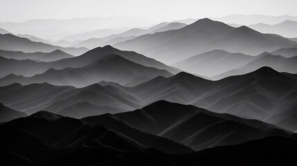 Rolling mountain layers fading into atmosphere, creating a serene black and white abstract landscape view