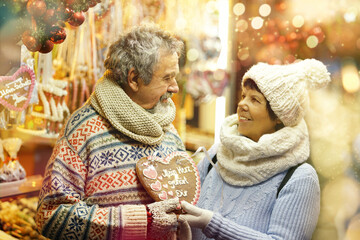 Candies On Christmas Market, happy elderly couple enjoy christmas