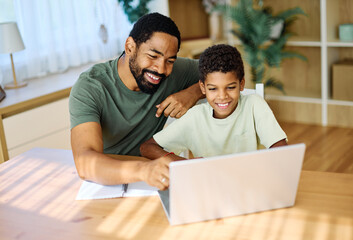 Father and son doing homework with laptop at home. Father and teenage son using laptop. Boy and dad sitting at home working with notebook