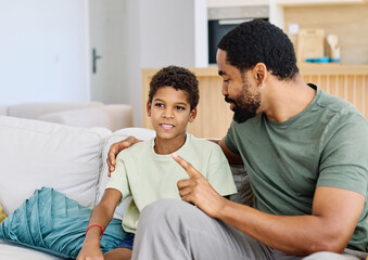 Portrait of a happy teenage boy son talking to his father at home. Sharing secrets and having fun, support and parenthood concept