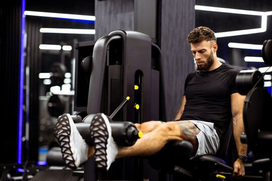 Leg extension workout at gym during evening session for muscle growth and strength