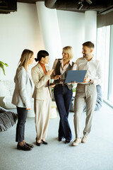 Professional team collaborating in a modern office setting during afternoon