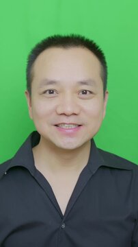Mature Asian man blows kiss, a man expressing love, man's reaction when find a beautiful woman, vertical portrait video.