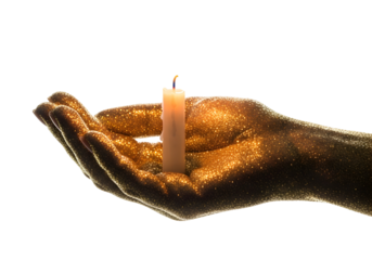 Close Up Of A Woman Hand Holding A Lit Candle Covered In Gold Glitter With A Black Background And Soft Lighting