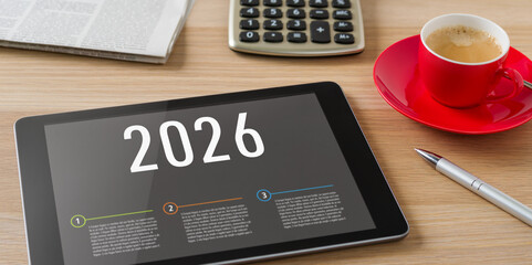A tablet on a desk with the headline 2026