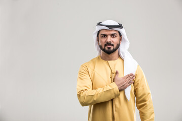arab man wearing emirati clothing posing in studio - Handsome middle-eastern businessman portrait