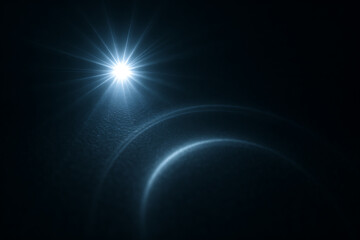 Blue lens flare effect with light beam and glowing circle on dark background