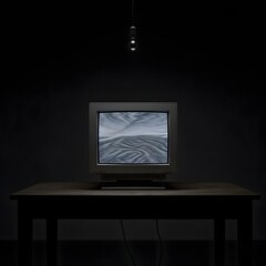 A vintage television set displaying static on a dark wooden table in a dimly lit room with a single hanging light bulb overhead