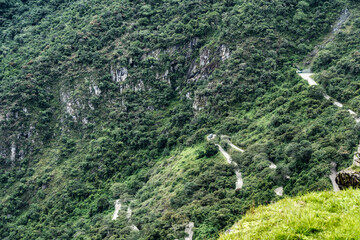 Scenic view from above with the winding dirt road to Machu Picchu starting from Aguas Calientes.