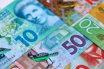 New Zealand dollar money bills in big amount on table close up. Rich life concept in New Zealand. Business and economy