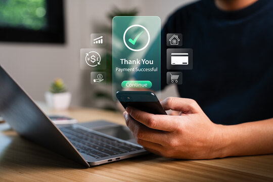 Man using smartphone for online payment with holographic thank you message showing payment successful and digital icons, representing fintech innovation, secure mobile transaction, cashless economy