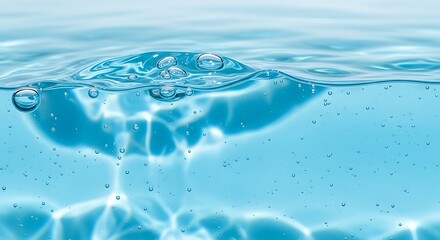 Clear blue liquid surface with bubbles and light reflections below.